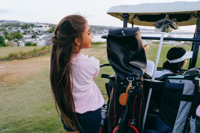 a woman standing next to a golf cart, pexels contest winner, happening, avatar image, bag, panoramic view of girl, medium close up shot