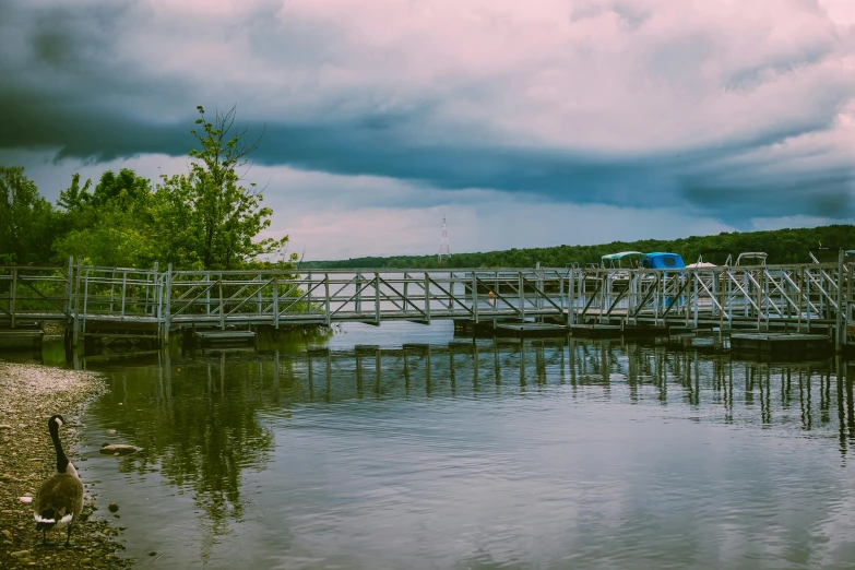 a bridge over a body of water under a cloudy sky, a picture, unsplash, process art, boat dock, minn, detailed color scan”, fishing