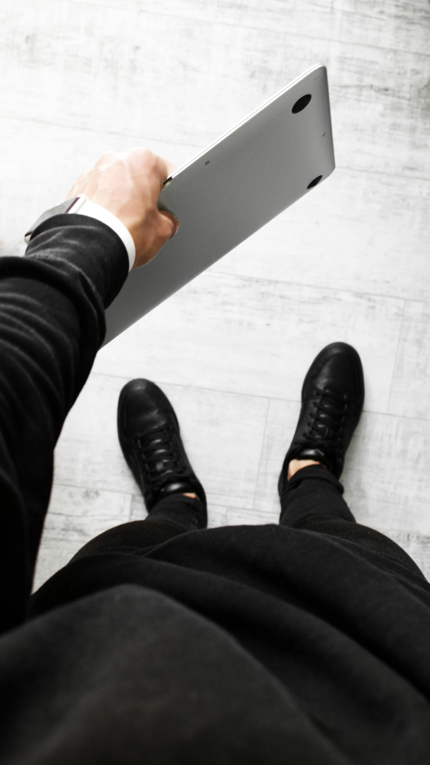 a man in a suit is holding a laptop, by Carey Morris, pexels contest winner, modernism, black shoes, instagram selfie, black floor, grey clothes