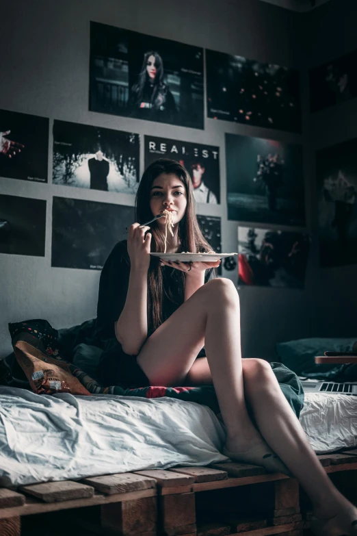 a woman sitting on a bed eating a piece of pizza, inspired by Elsa Bleda, pexels contest winner, aestheticism, cyberpunk teenager bedroom, lots of pictures, young and slender