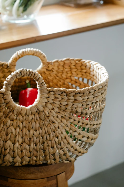 a basket sitting on top of a wooden stool, zoomed in, product display photograph, fruit bowl, close up face detail