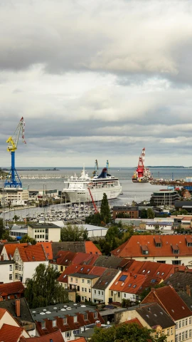 a view of a harbor with a cruise ship in the distance, by Harry Haenigsen, pexels contest winner, happening, bjarke ingels, square, crane, prussia