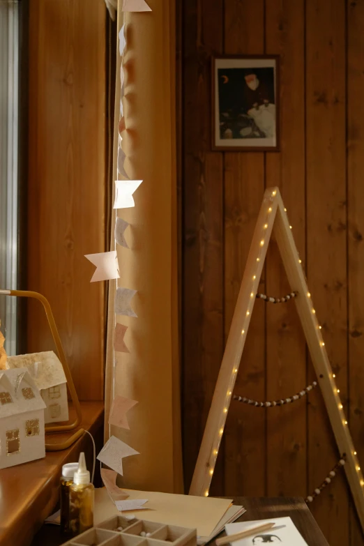 a teddy bear sitting on top of a desk next to a window, string lights, 165 cm tall, red pennants, chalet