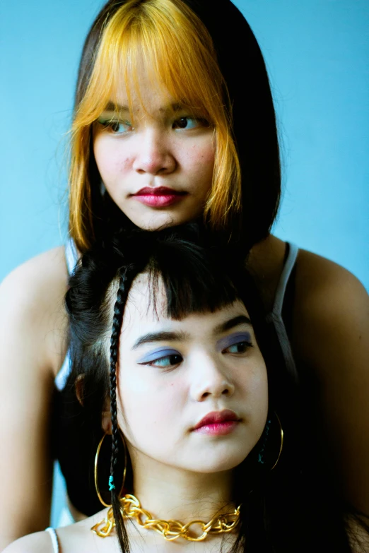 a couple of women standing next to each other, an album cover, inspired by Wang Duo, flickr, colorful pigtail, south east asian with round face, color photograph portrait 4k, ((portrait))