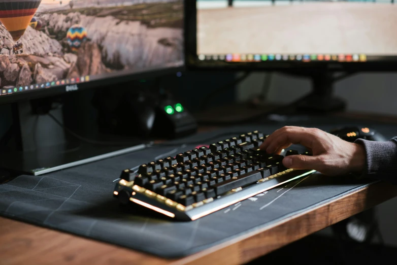 a close up of a person typing on a keyboard, a computer rendering, by Dan Content, unsplash, gamer screen on metallic desk, on a wooden desk, brass equipment and computers, background image