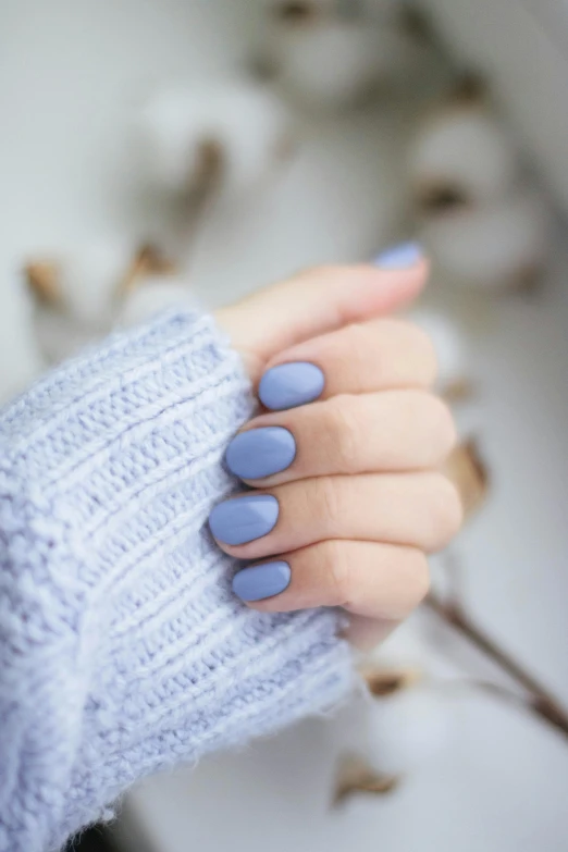 a close up of a person's hand with blue nail polish, shutterstock, aestheticism, lilac, blue sweater, vmk myvmk, soft coloring