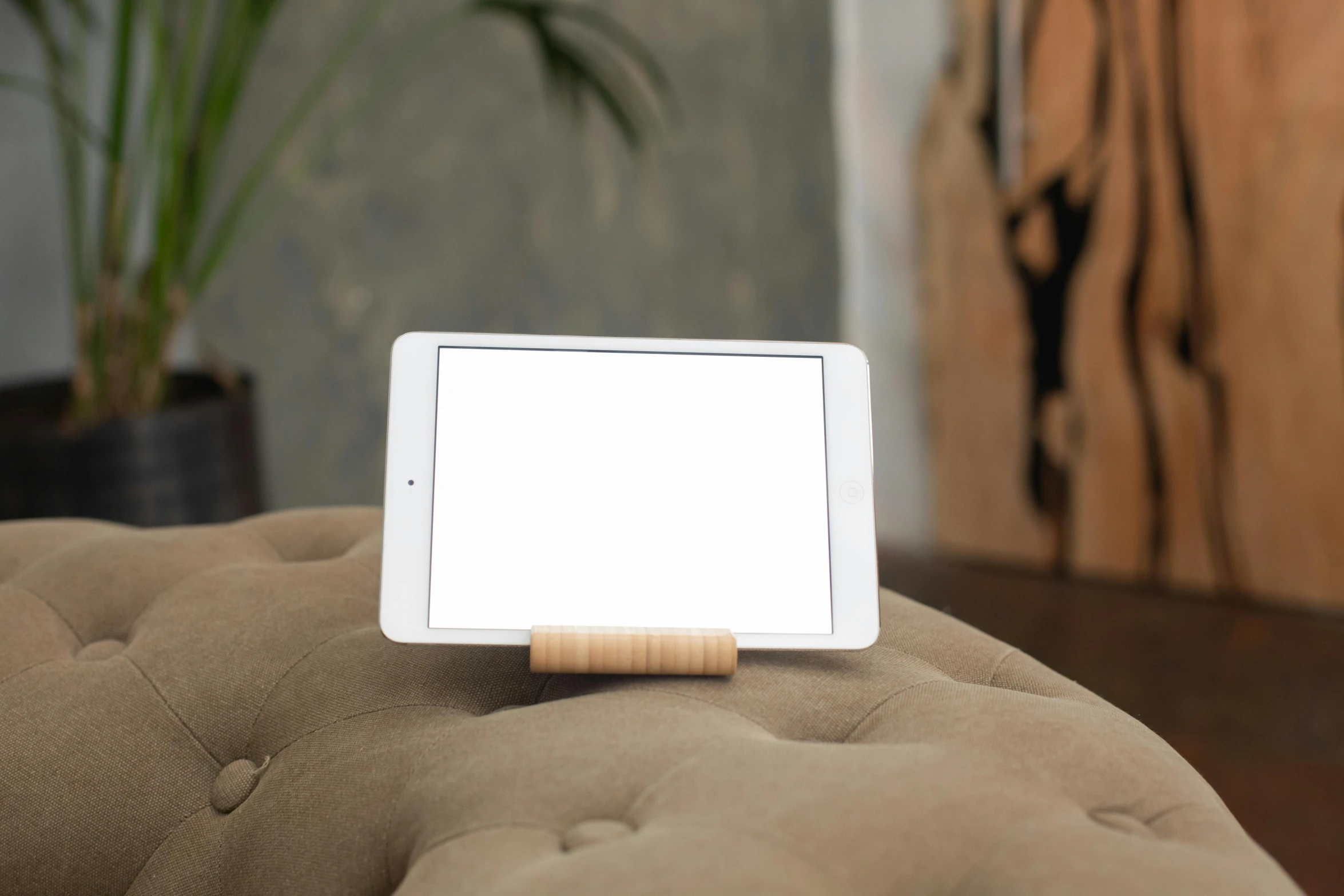 a tablet computer sitting on top of a couch, inspired by Isamu Noguchi, light wood, selfie, small, screen light