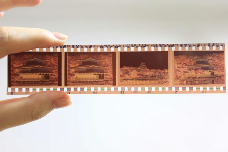 a close up of a person holding a film strip, inspired by Tōshi Yoshida, unsplash, preserved historical, cinemascope panorama, 1990s photograph, rinko kawauchi