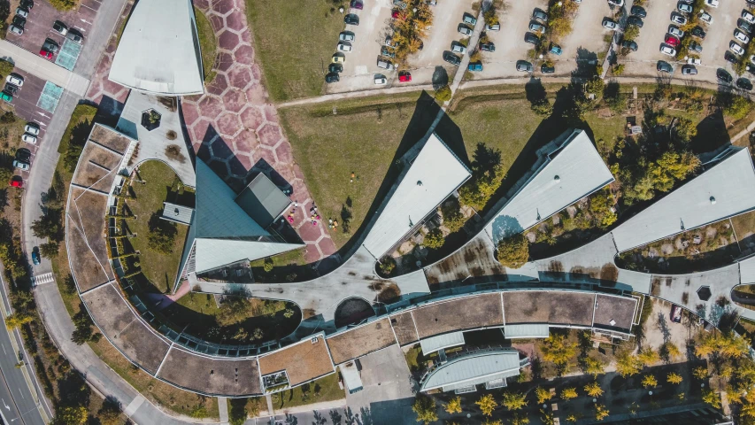 a bird's eye view of a parking lot, a digital rendering, by Adam Marczyński, pexels contest winner, modernism, school courtyard, curvy build, elegant walkways between towers, thumbnail