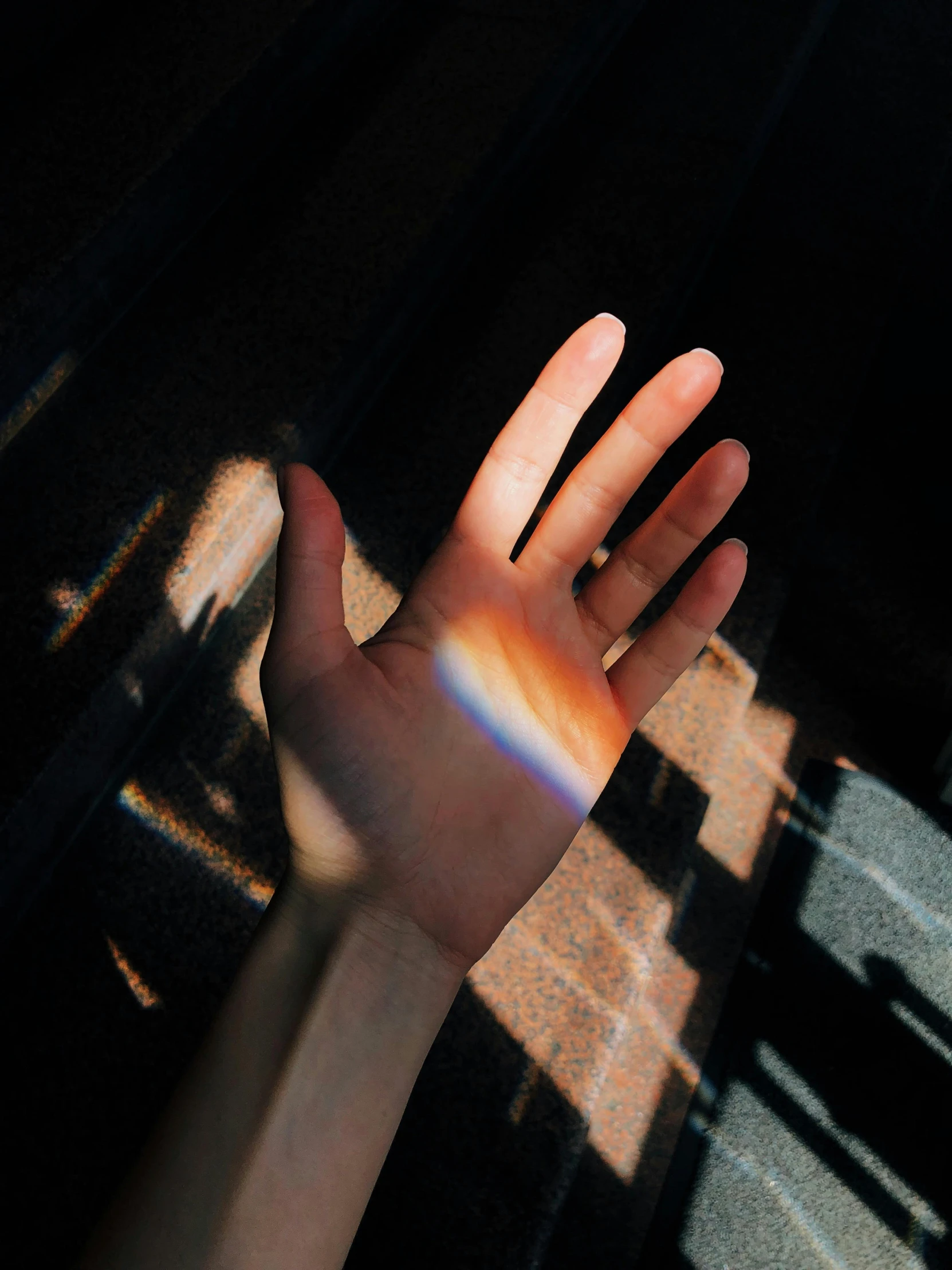 a person holding their hand out in the sun, inspired by Elsa Bleda, trending on unsplash, light and space, dark rainbow, translucent skin, instagram story, soft light through blinds