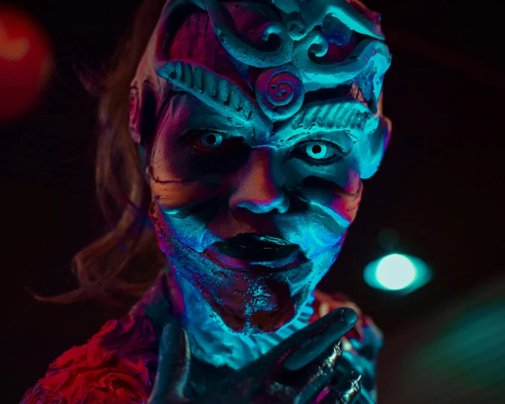 a close up of a person with face paint, cyberpunk art, turquoise and pink lighting, 1 3 ghosts movie artwork, triadic color grading, cory chase as an atlantean