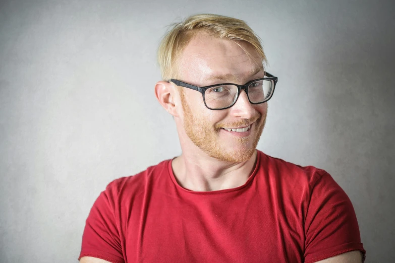 a man wearing glasses and a red shirt, a character portrait, by Niels Lergaard, pexels contest winner, hr ginger, avatar with a blond hair, plain background, 3 2 - year - old