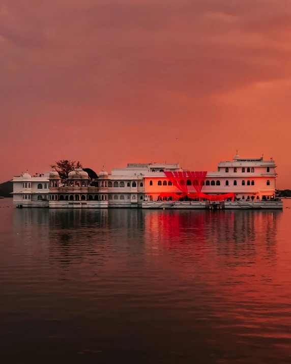 a large boat floating on top of a body of water, by Saurabh Jethani, pexels contest winner, renaissance, red and orange glow, palace, lgbtq, panoramic shot