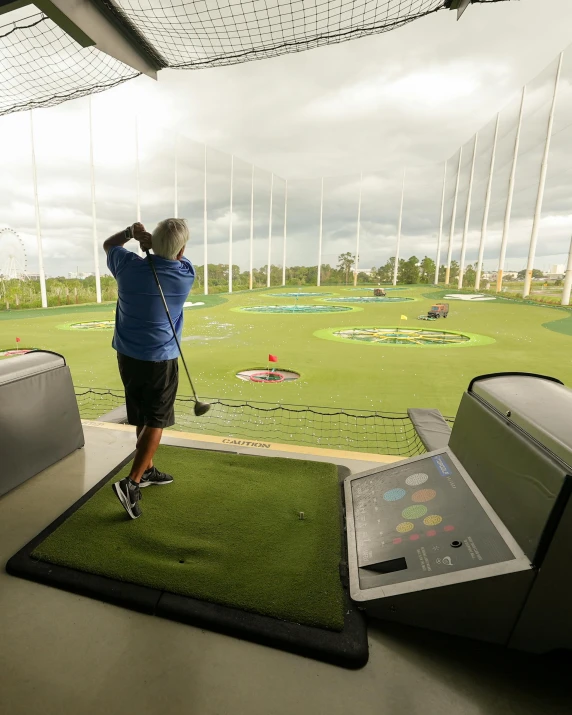 a man taking a swing at a golf course, a photo, happening, inside in a glass box, jets, lgbtq, chamber