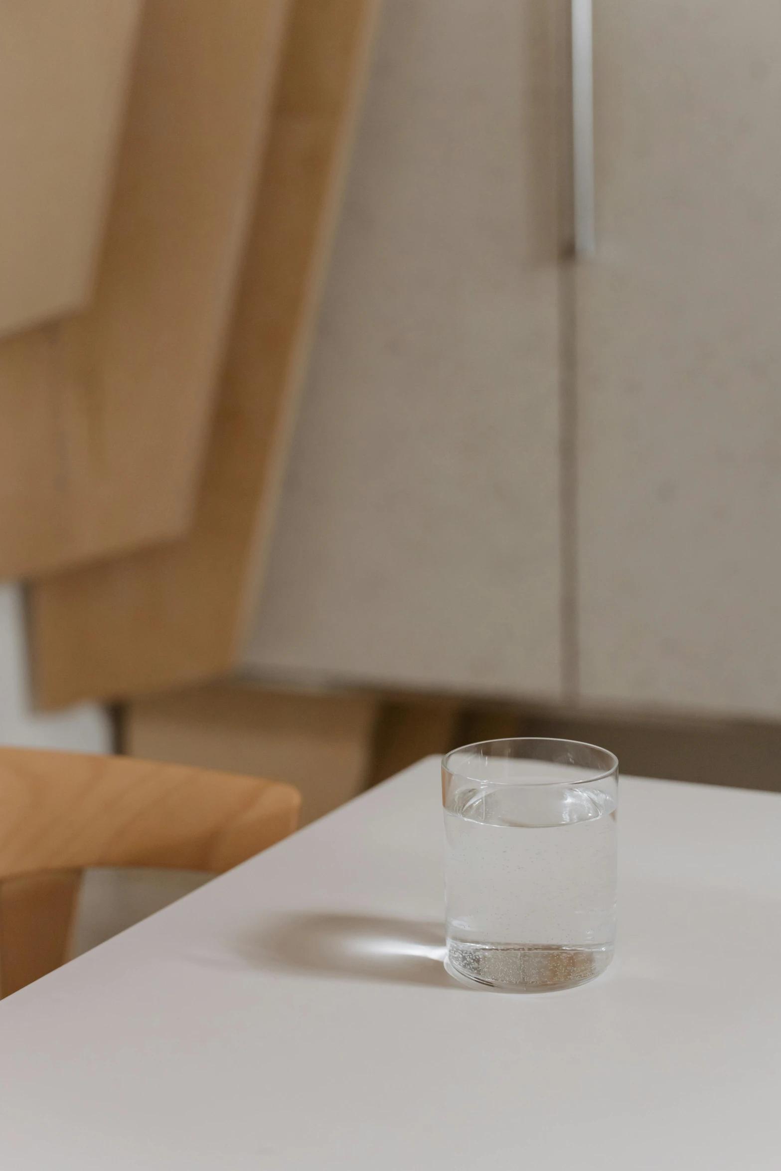 a glass of water sitting on top of a table, by Harvey Quaytman, sustainable materials, sparse detail, contaning tables and walls, dao lee