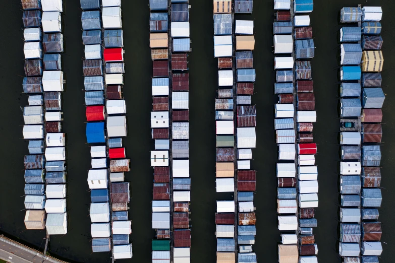 a number of boats in a body of water, inspired by Andreas Gursky, unsplash contest winner, conceptual art, shipping containers, square lines, stacked, various colors