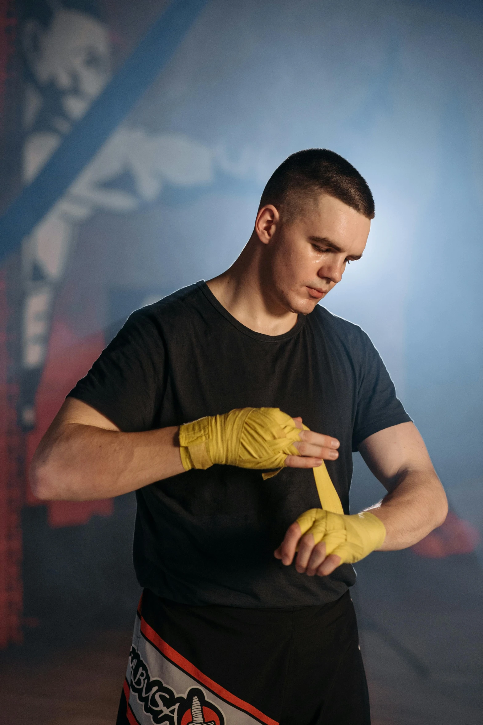 a man in a black shirt and yellow gloves, by Ilya Ostroukhov, pexels contest winner, white bandage tape on fists, profile pic, performance, dasha taran