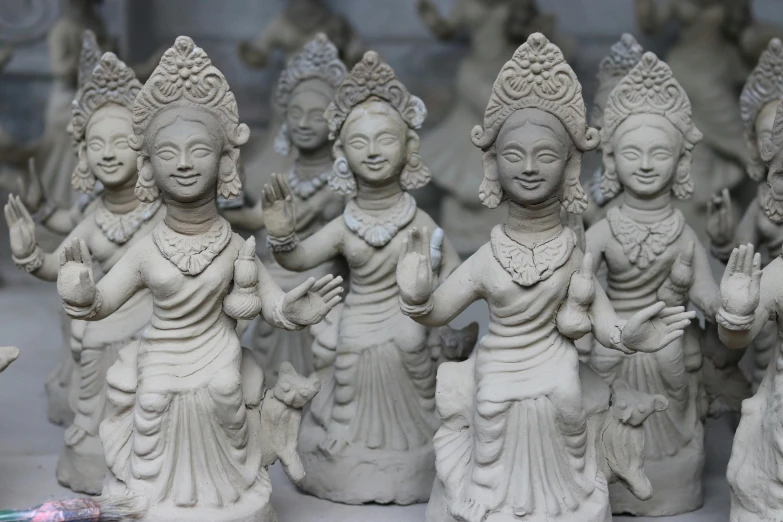 a group of statues sitting on top of a table, bengal school of art, fan favorite, white clay, family friendly, festivals