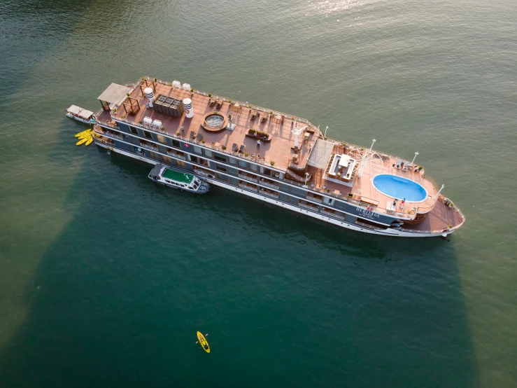 a large boat floating on top of a body of water, gold, arial shot, fan favorite, fully decorated