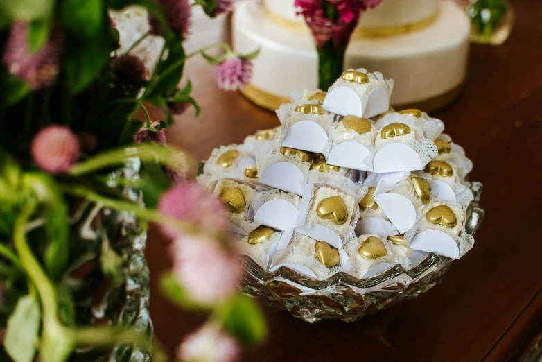 a wedding cake sitting on top of a wooden table, chocolate candy bar packaging, gold plated, thumbnail, sunday afternoon