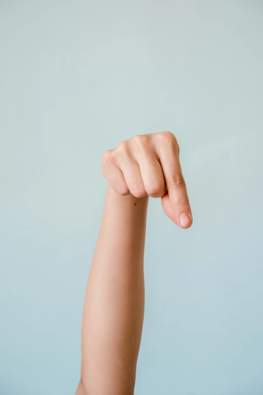 a close up of a person's arm with a toothbrush in it, an album cover, unsplash, hypermodernism, fighter pose, very thin, cysts, the letter w