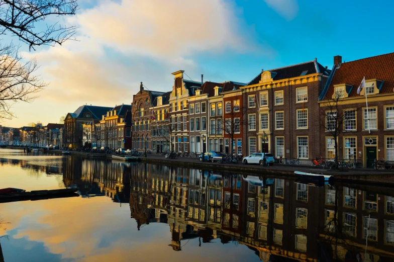 a row of buildings next to a body of water, by Jan Tengnagel, pexels contest winner, neoclassicism, delft, warm light, square, thumbnail