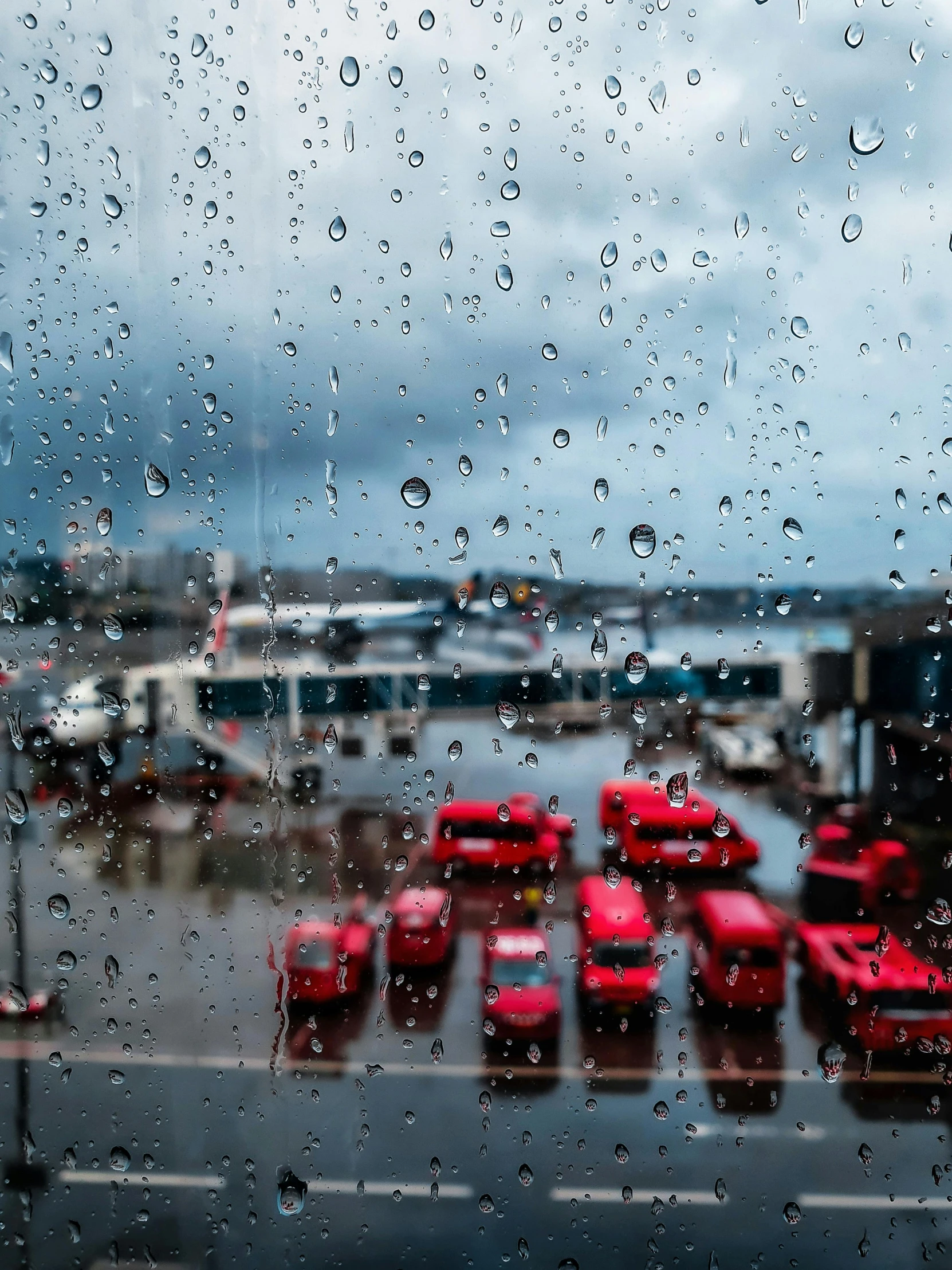 a bunch of buses that are sitting in the rain, inspired by Thomas Struth, pexels contest winner, looking out at a red ocean, hamar, it\'s raining, window ( rain )