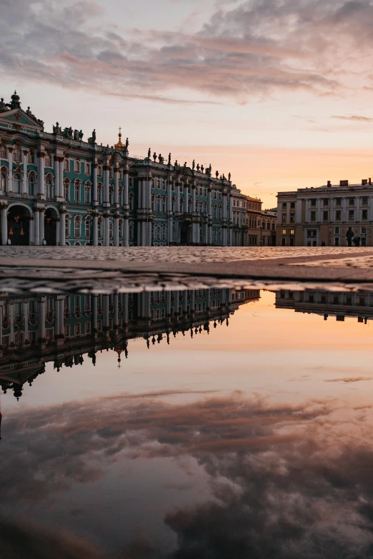 a reflection of a building in a puddle of water, a picture, pexels contest winner, baroque, russian neoclassicism, at dawn, square, high-quality photo