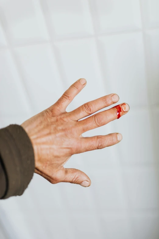 a close up of a person's hand with blood on it, point finger with ring on it, recovering from pain, tall, insisted on cutting in line