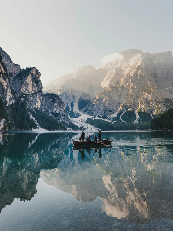 a group of people in a boat on a lake, pexels contest winner, romanticism, dolomites in the background, high quality product image”