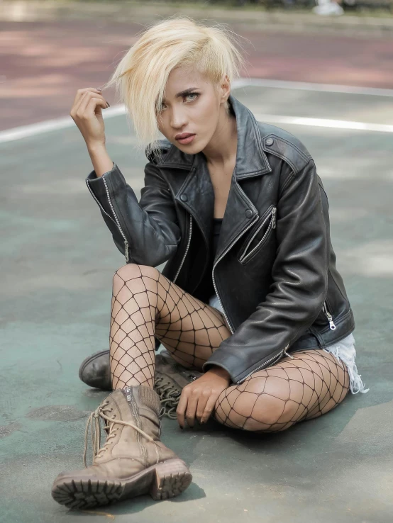 a woman sitting on top of a tennis court, an album cover, trending on pexels, photorealism, leather clothing and boots, non binary model, fishnet, 5 0 0 px models