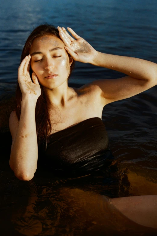 a woman sitting in the water with her eyes closed, heat shimmering, modelling, bedhead, a young asian woman