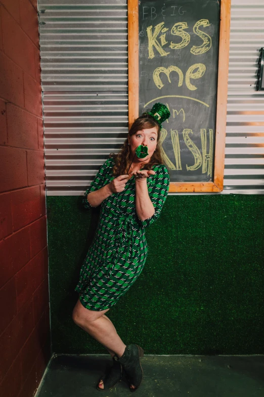 a woman in a green dress leaning against a wall, by Meredith Dillman, unsplash, kitsch movement, photo booth, booze, clover, 2 5 6 x 2 5 6 pixels