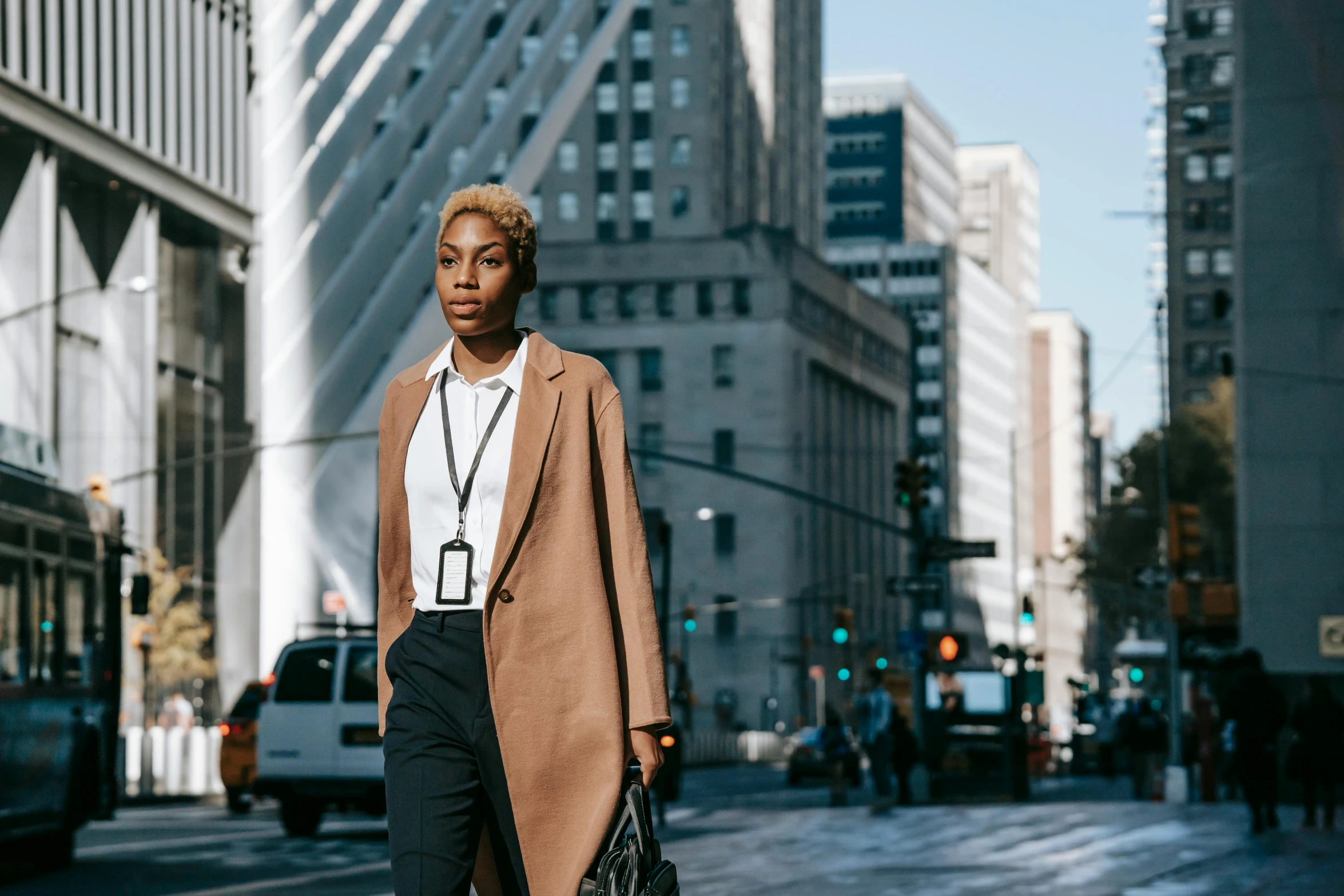 a woman standing in the middle of a city street, trending on pexels, lawyer clothing, brown skinned, androgyny, work clothes