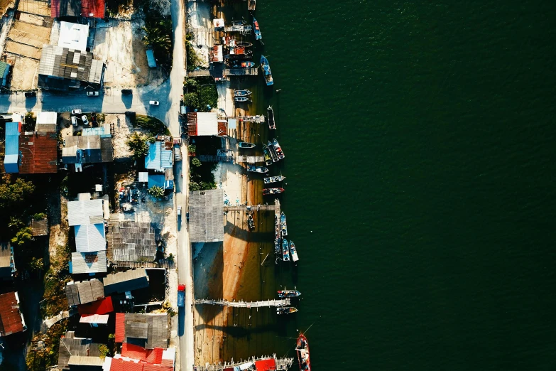 a large boat in the middle of a body of water, a tilt shift photo, pexels contest winner, photorealism, shanty town, satellite imagery, various colors, high-contrast