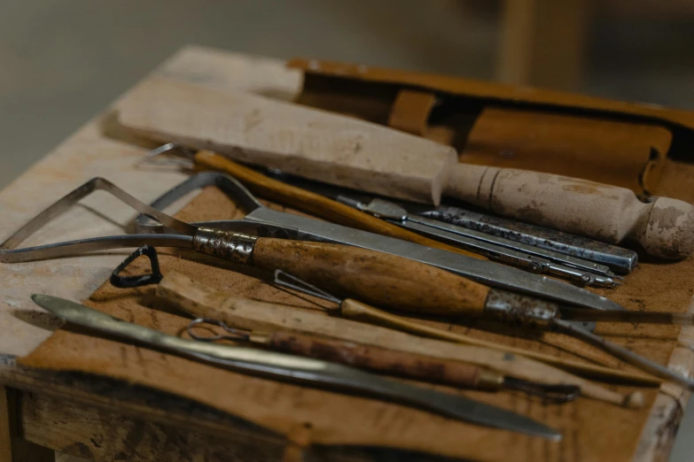 a bunch of tools sitting on top of a wooden table, documentary still, delicate and precise brushwork, thumbnail, restomod