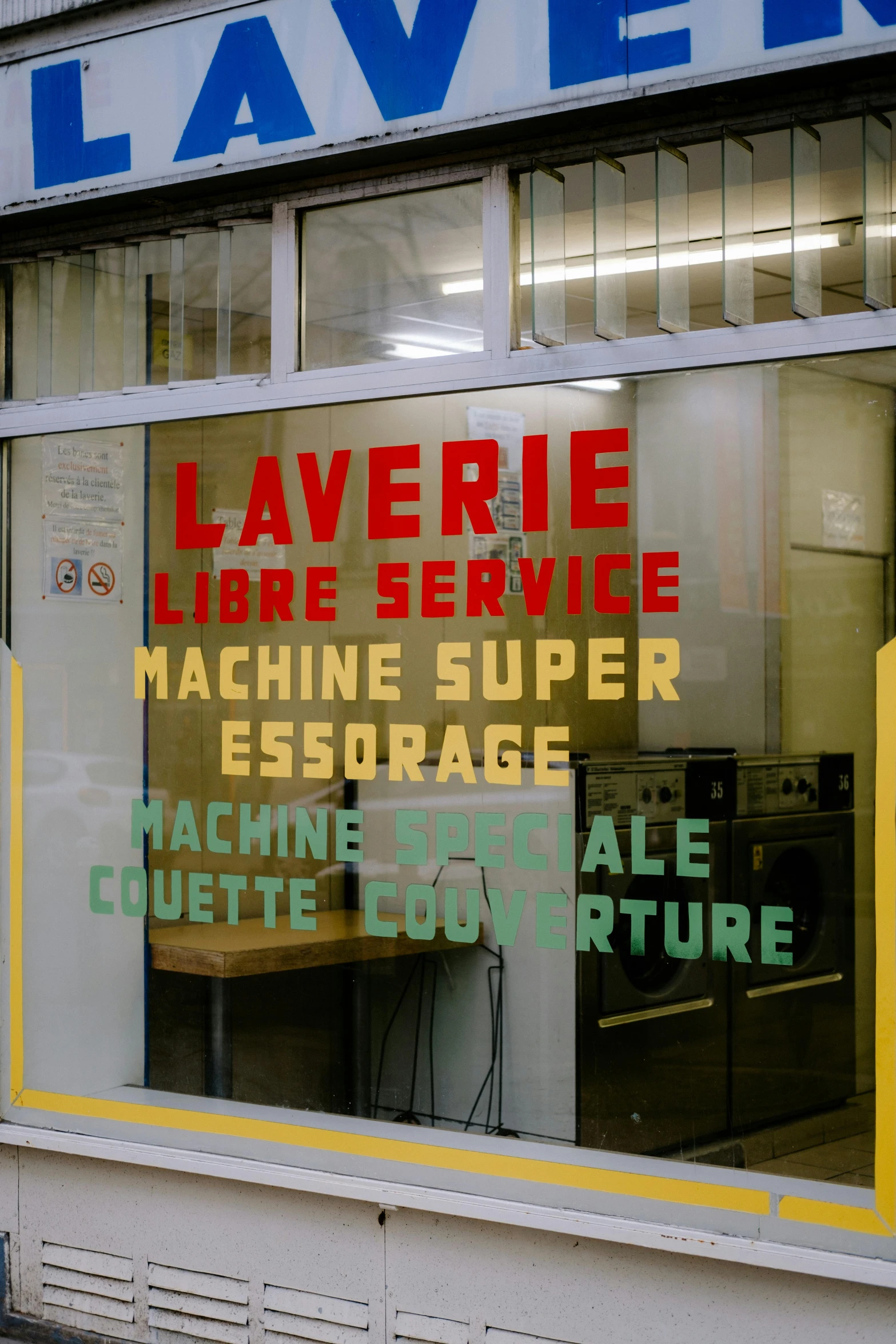 a store front with a sign that says laven laven laven laven laven laven laven laven laven laven, a silk screen, by Pierre Laffillé, international typographic style, washing machine, archille superbi, in an underground laboratory, scene from supplizia