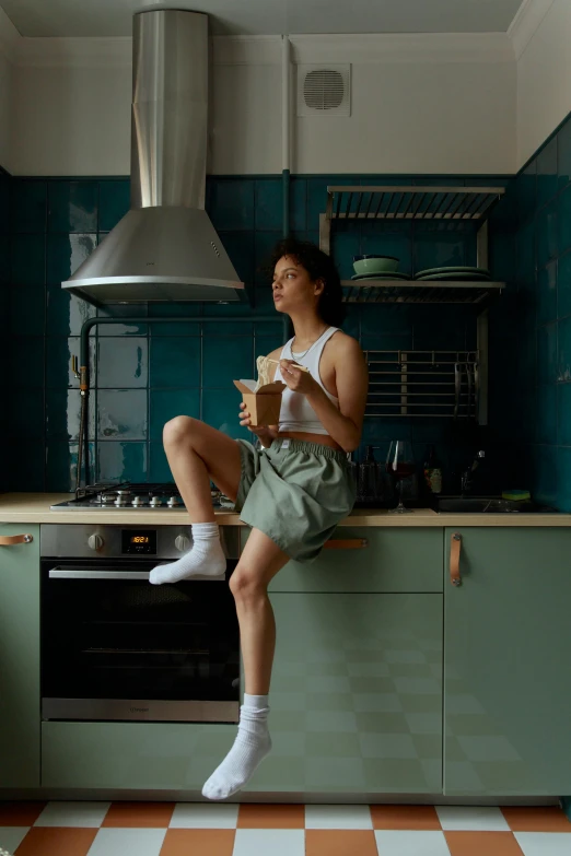 a woman sitting on a counter in a kitchen, inspired by Elsa Bleda, pexels contest winner, bra and shorts streetwear, greens), milk and mocha style, alexey egorov