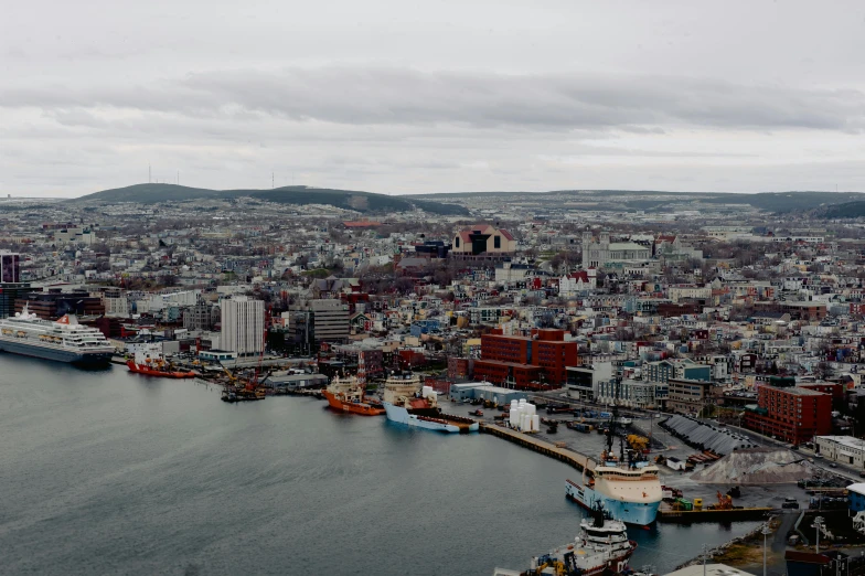 a large body of water next to a city, by Brian Snøddy, pexels contest winner, hurufiyya, shipyard, grey, slide show, full colour
