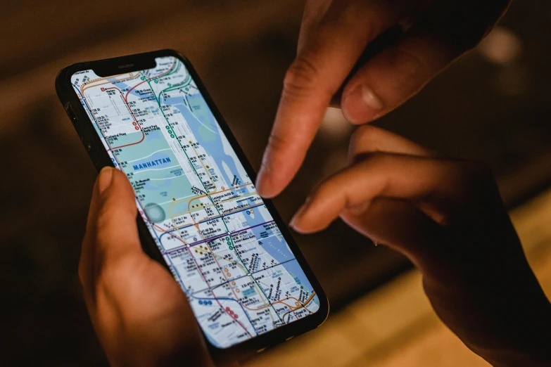 a person holding a cell phone with a map on it, pexels, avatar image, iphone 12, close up photo, 1 2 9 7