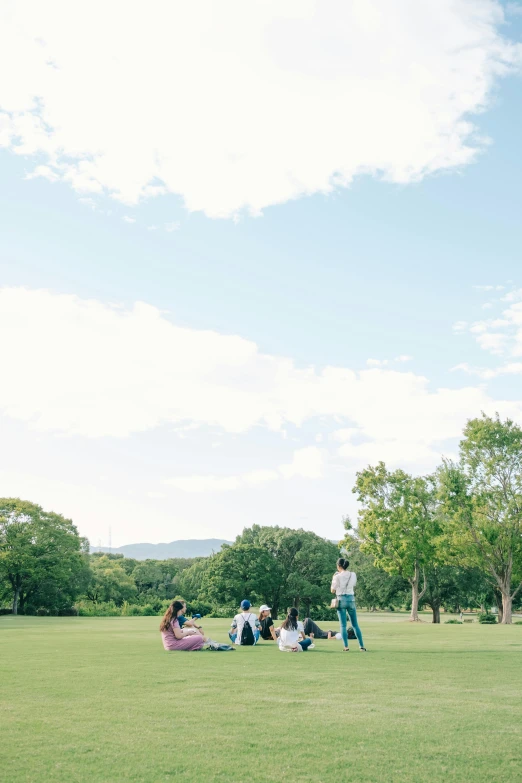 a group of people sitting on top of a lush green field, by Katsukawa Shun'ei, trending on unsplash, visual art, golf course, picnic, instagram story, long shot wide shot full shot