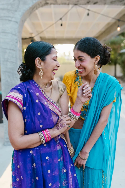 a couple of women standing next to each other, a portrait, by Meredith Dillman, pexels, dressed in a sari, smiling at each other, daughter, 2 5 6 x 2 5 6 pixels