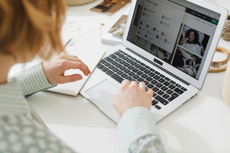 a woman sitting at a desk using a laptop computer, a picture, trending on pexels, bottom angle, 9 9 designs, thumbnail, close up to the screen