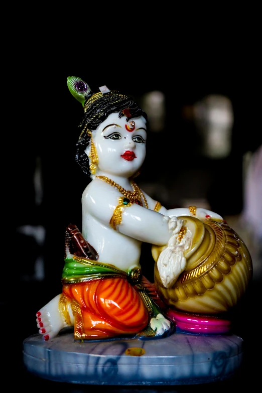 a small figurine sitting on top of a table, by Sudip Roy, full of colors and rich detail, slide show, creamy, kek