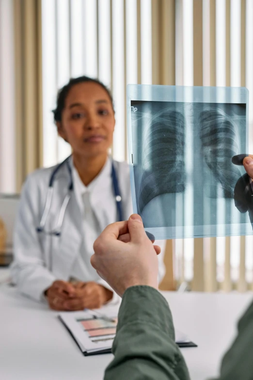 a doctor showing an x - ray to a patient, a picture, pexels contest winner, renaissance, respiratory flap, a small, diverse, person in foreground