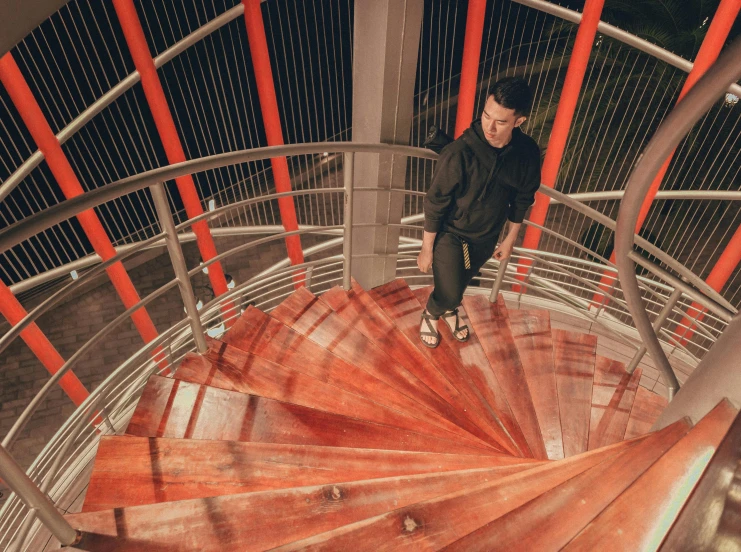 a man standing at the top of a spiral staircase, rex orange county, sasai ukon masanao, zenith view, jc park