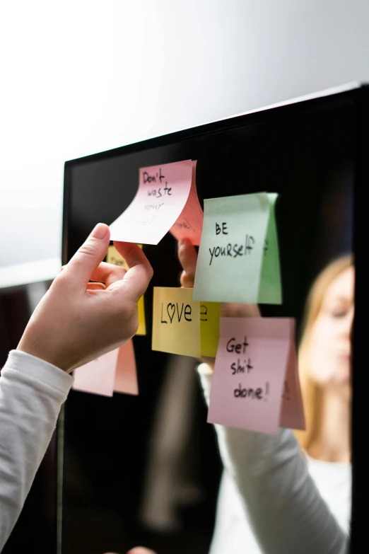 a person putting sticky notes on a computer screen, saying, holding close, hyperdetailed, close together