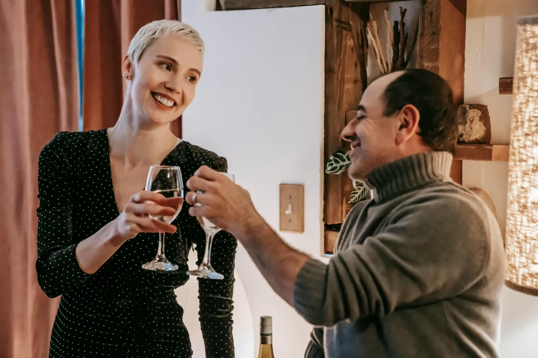 a man and a woman sharing a glass of wine, pexels contest winner, renaissance, hygge, standing still, award-winning style, at home