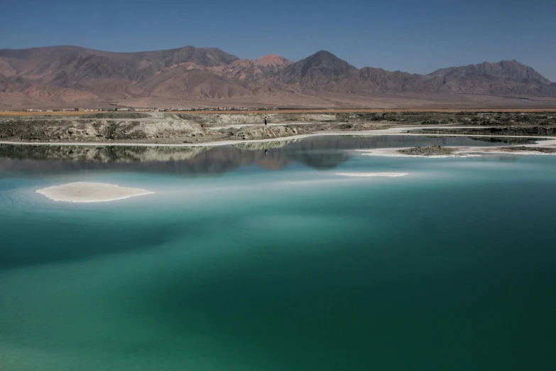 a body of water with mountains in the background, blue and green water, nekro petros afshar, alessio albi, in chuquicamata