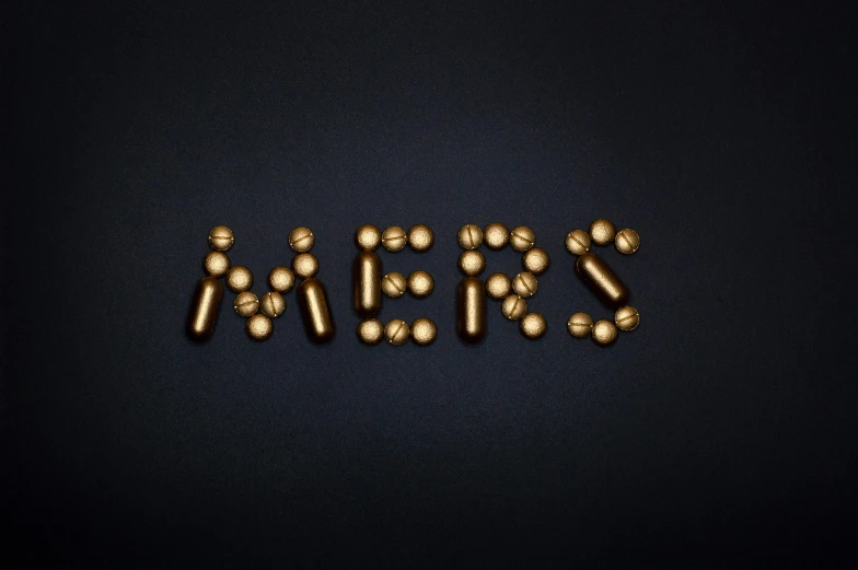 a word made out of gold pills on a black background, an album cover, inspired by Hans Mertens, mars base, mert and marcus, yes, embers